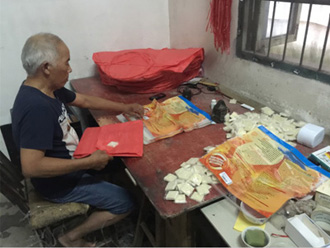 A villager is packing flying lantern in his home